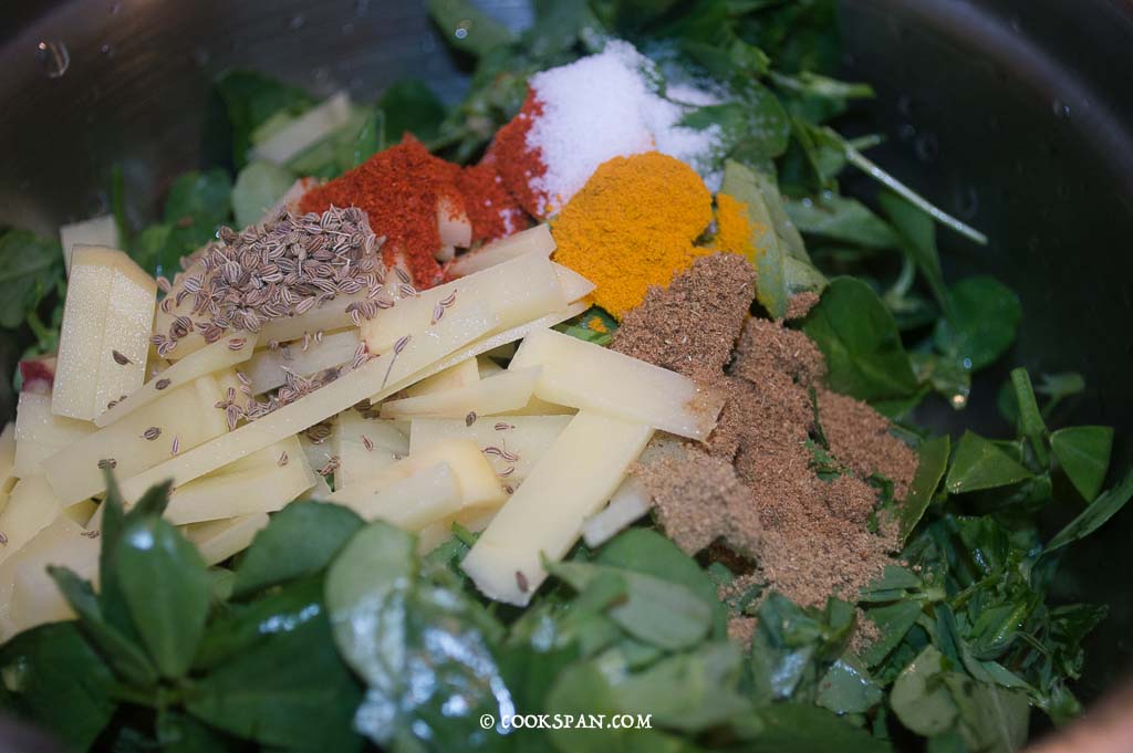 Adding the Powdered spices to the pakodas