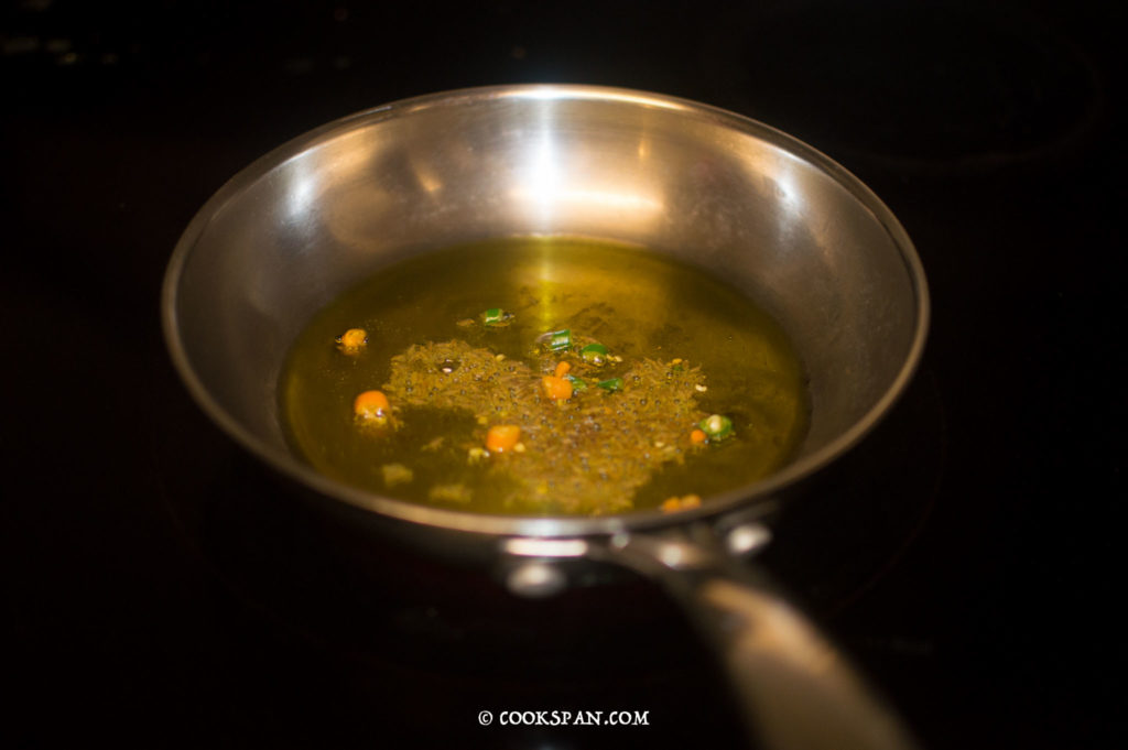 Green chilies and cumin seeds in the oil