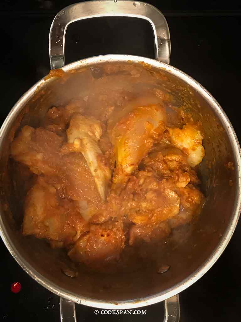Mixing the chicken with the cooked Masalas
